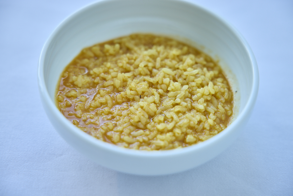 A fish soup characterized by its vibrant orange color. (Photo by Norio Kidera) 