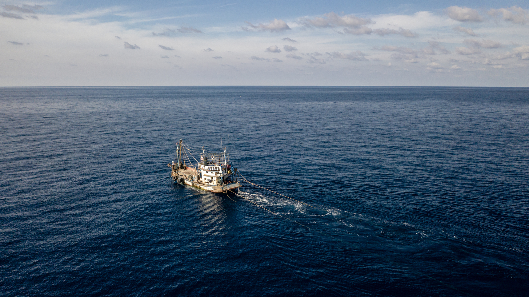 Fishing boats sailing the vast ocean © Environmental Justice Foundation 